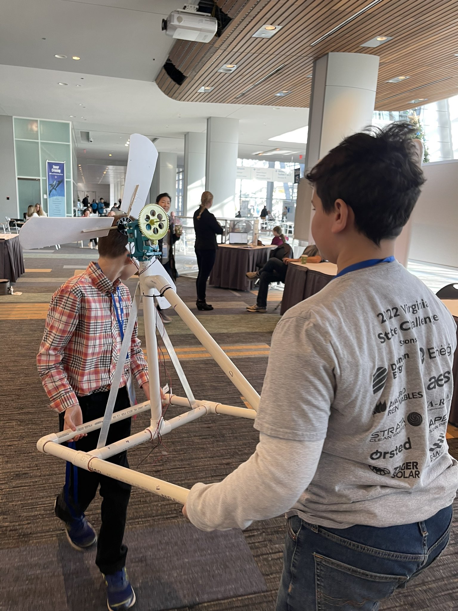 Kids moving their wind turbine on display the 2022 VSTE Conference. 