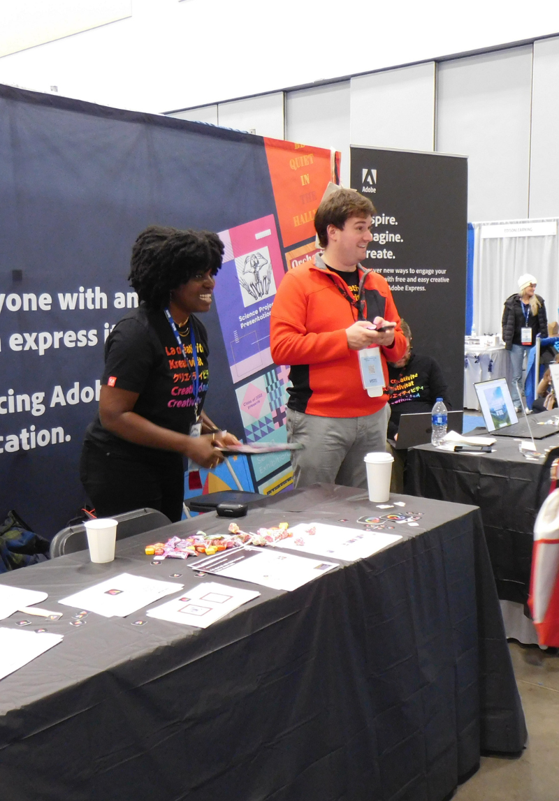 Canva exhibitors interacting with conference attendees.